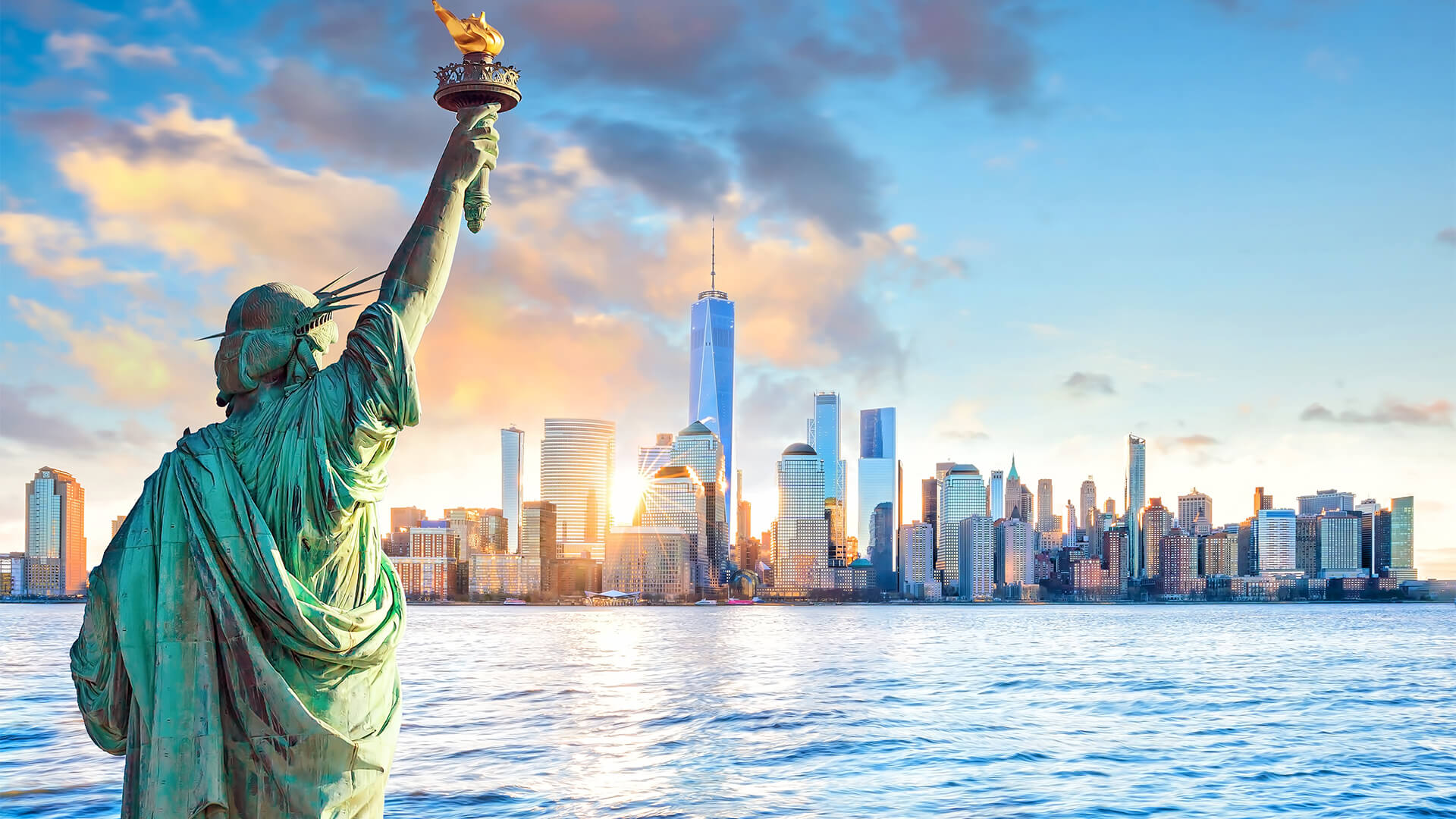 Statue of Liberty looking at Manhattan during a sunset, New York