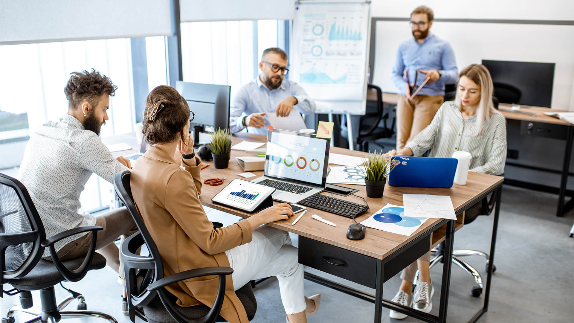 Five people in an office having a meeting