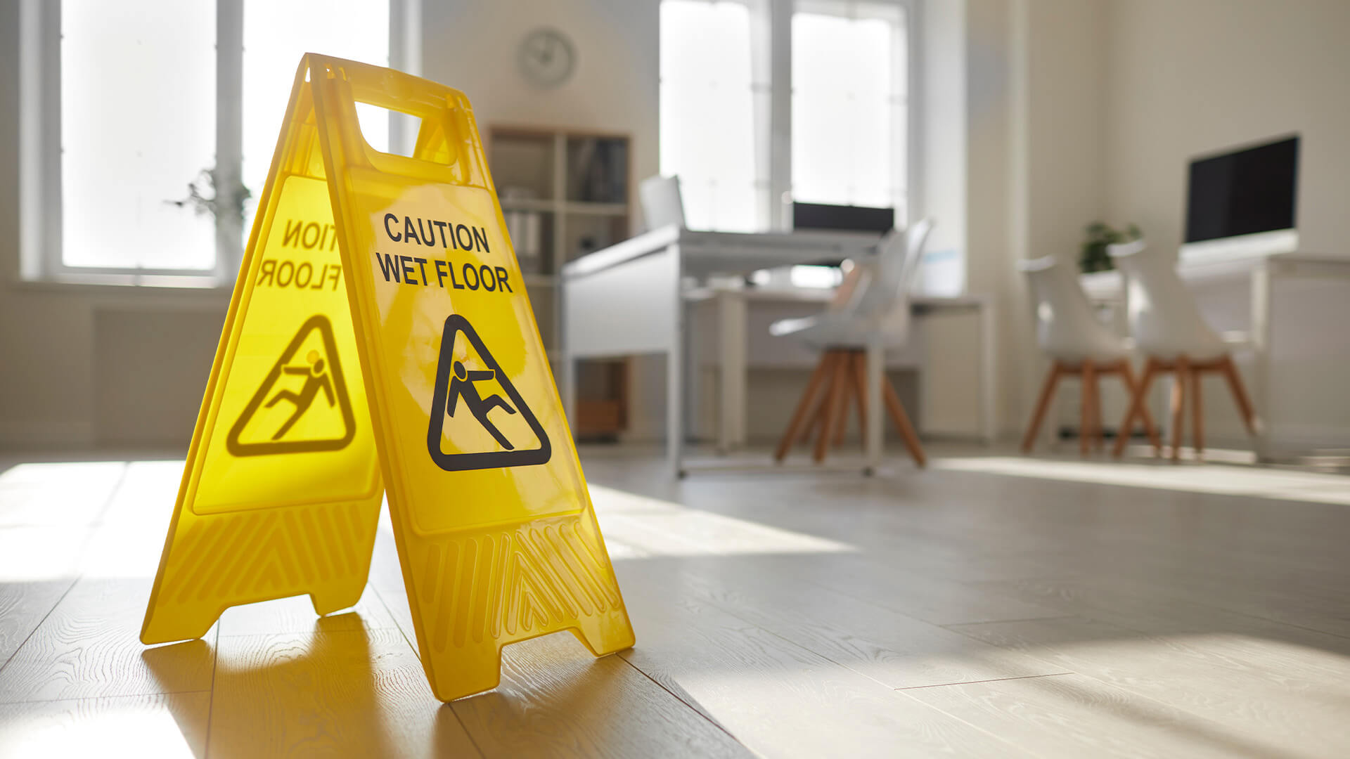 Yellow "wet floor" sign in an office