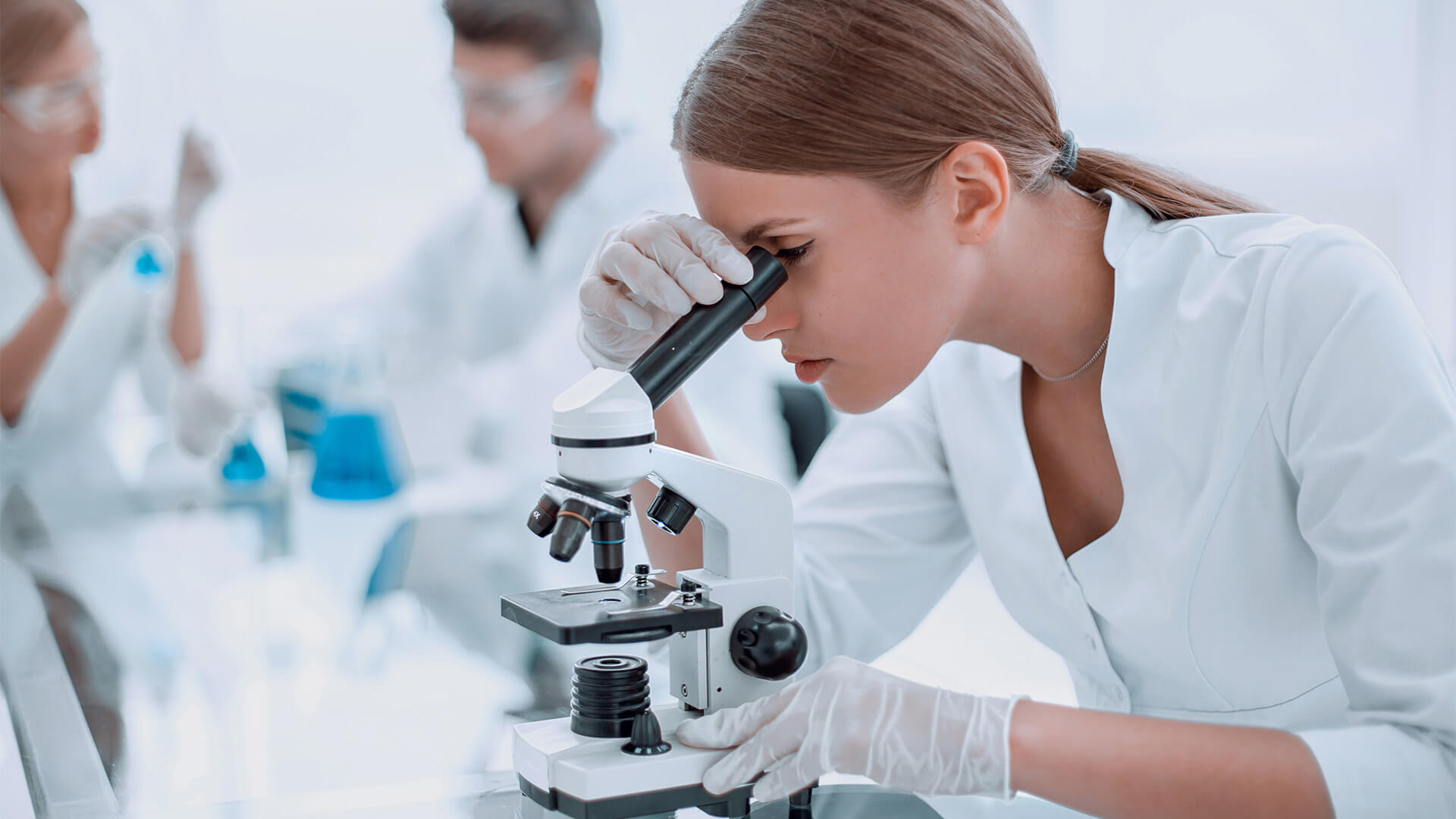 female scientist using a microscope in a chemical laboratory