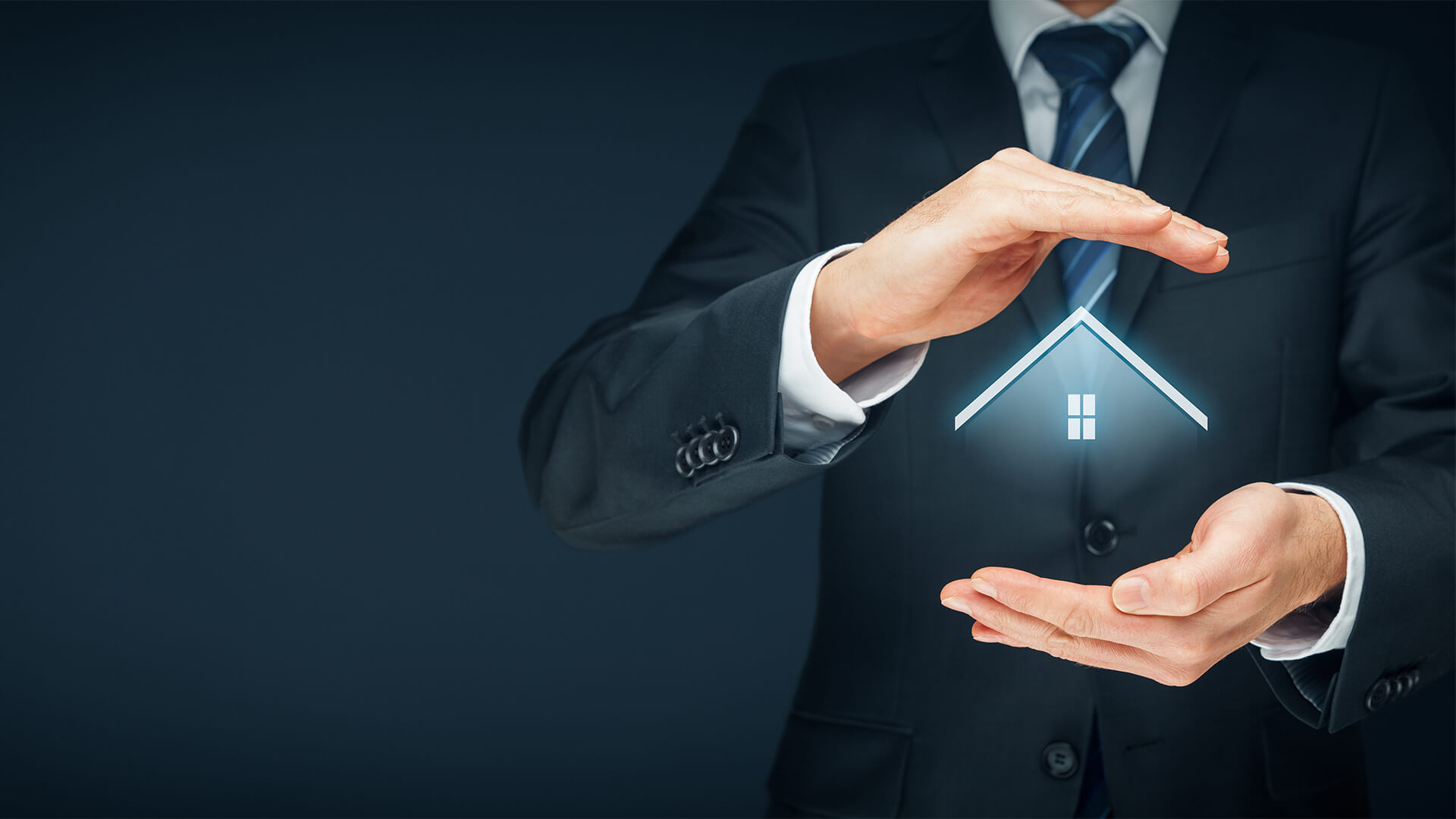 man in suit holding roof and window in between hands