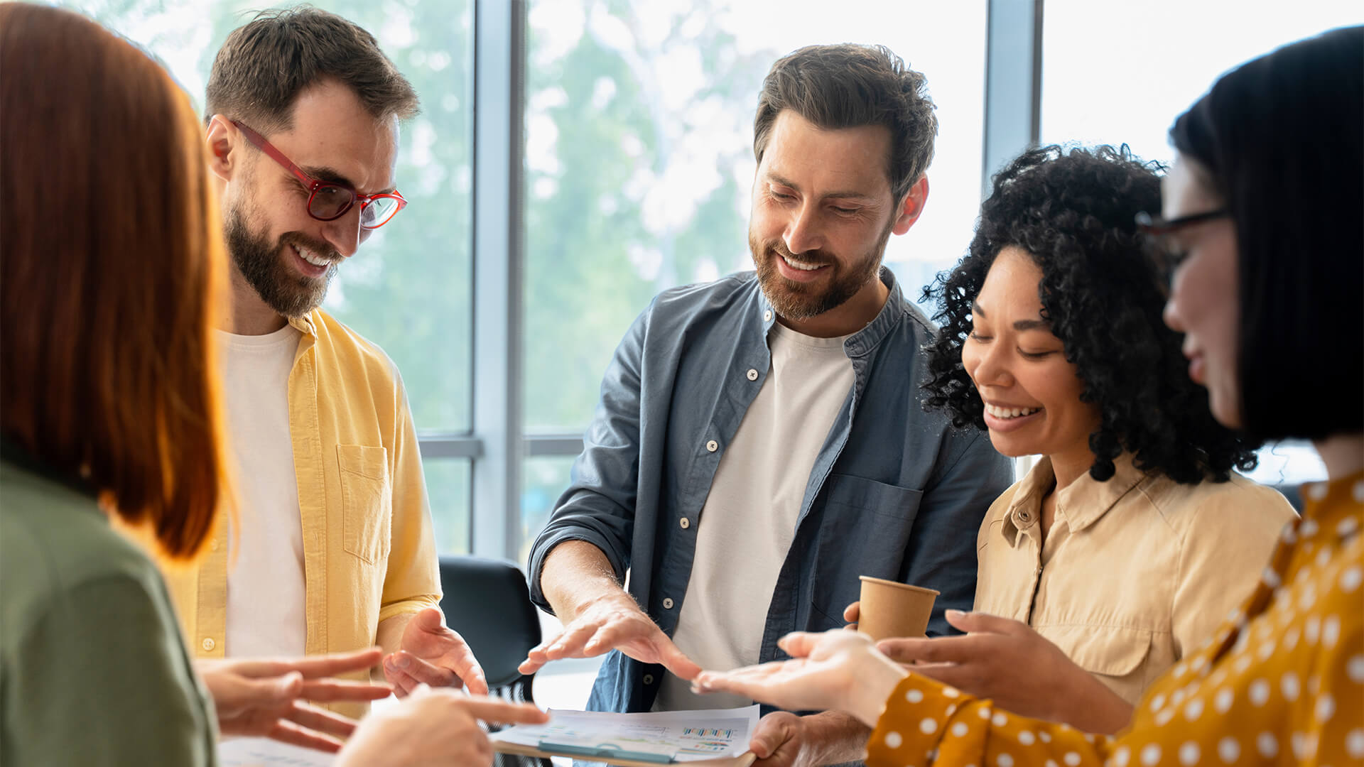 Group of diverse business people discussing charts with quartal sales growth in office interior