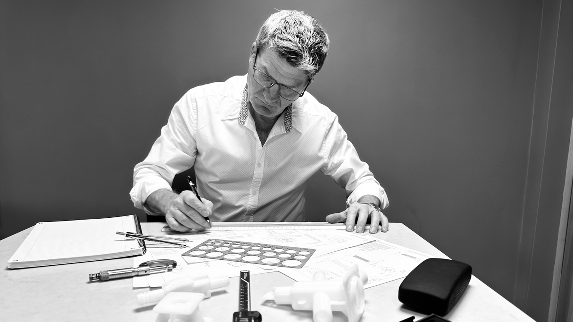 Steve Harding sitting at a table drawing